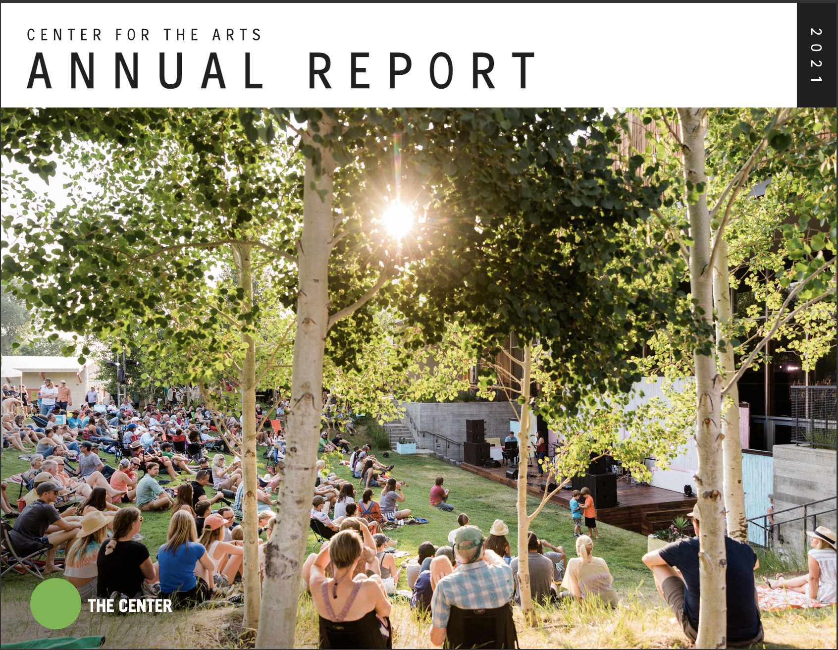 Center for the arts annual report 2021 cover, showing the lawn of the center full of people sitting in the sun enjoying a show